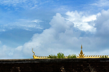 Fototapeta premium Roof of Laos Buddhist Temple on the blue sky