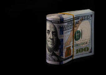 Stack of American dollars on a black background