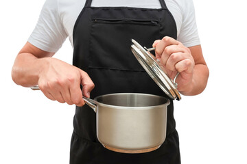 A man in an apron opening a pot with a lid isolated on a white background. Cooking concept