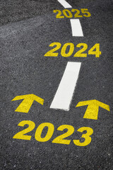 Road to year 2023, 2024, 2025 with yellow arrow marking on road. Making money retirement concept...