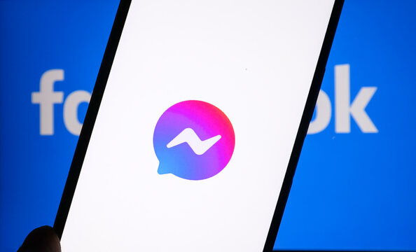 Facebook messenger logo on phone screen and Facebook logo background on computer screen., June 8, 2022, Chiang Mai, Thailand.