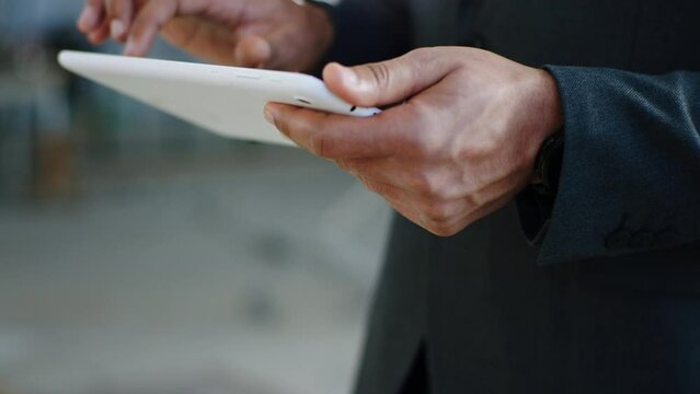 Taking video details of a businessman holding digital tablet and make some notes at construction site