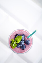 Blueberry smoothie closeup. Fruit smoothie with mint leaf © virtustudio