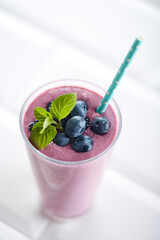 Blueberry smoothie closeup. Fruit smoothie with mint leaf