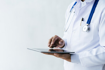 Male doctor using his digital tablet in the consultation.Medicine and healthcare concept