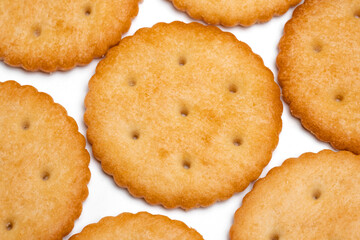 Healthy whole wheat cracker on white background. Stack of Saltine crackers isolated on white background. Round crackers.