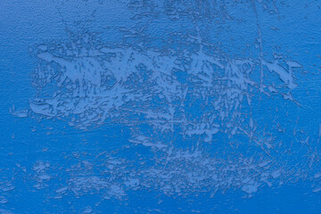 Blue peeling cracked off the outdoor flap wall, Dirty grunge abstract background from weathering.