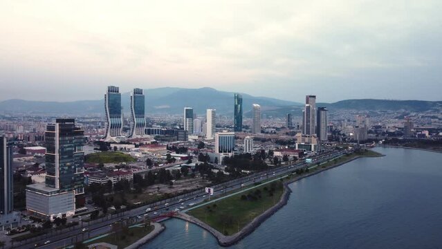 Izmir, Turkey - April 15, 2022: Aerial footage view of Izmir city from above Izmir bay sea with the skyscrappers which ones Folkart Towers, mistral, Ege Perla and Bayrakli region
