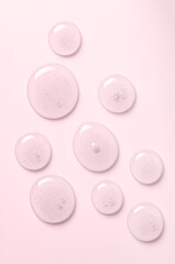 Pink drops of gel closeup. Cosmetic product for moisturizing the skin of the face or body.