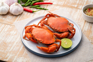Steamed Crab,Boiled Serrated mud crab in a plate with seafood sauce