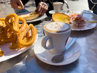 Spanish tapas in the restaurant- coffee cup,  churros and toast