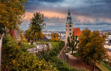 Fototapeta premium Wonderful view on iconic view of the historic city of Salzburgwith Muellner Church and river Salzach. Amazing landscape with picturesque sky during sunset. Salzburger Land, Austria