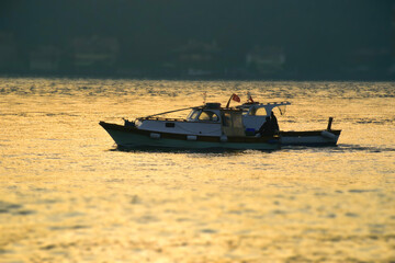 Men on a boat in Bosphorus waters in Istanbul. Fisherman in boat in Istanbul. Turkish fisherman sailing in boat in sea.