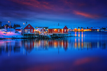 Fototapeta premium Scenic photo of winter fishing village with colorful sky. Vivid north landscape with reflected. Picturesque Scenery of Reinefjord one most popular place of Lofoten islands. Norway. ideal resting place