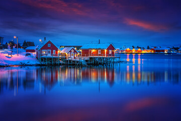 Scenic photo of winter fishing village with colorful sky. Vivid north landscape with reflected....