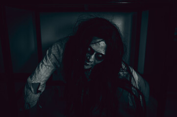 Portrait of asian woman make up ghost,Scary horror scene for background,Halloween festival concept,Ghost movies poster,angry spirit in the apartment