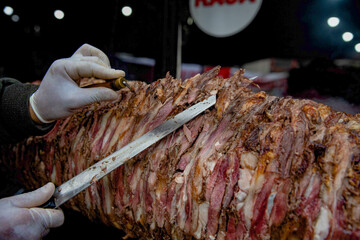 Cag Kebap, Traditional Turkish Kebap being prepared by chef. Slicing kebab to serve. stock photo
