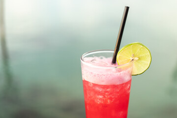 Summer Vacation Concept : Fruit cocktail glass. Welcome drink put on wooden table nearly the sea.