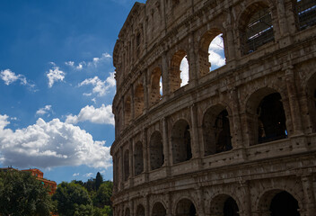 The ancient Colosseum located in Rome Italy during the summer.