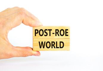 Roe vs Wade post-Roe world symbol. Concept words Post-Roe world on wooden blocks on a beautiful white background. Businessman hand. Business and Roe vs Wade post-Roe world concept. Copy space.