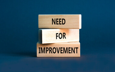 Naklejka premium Need for improvement and support symbol. Concept words Need for improvement on wooden blocks. Beautiful grey table grey background. Business, need for improvement quote concept. Copy space.
