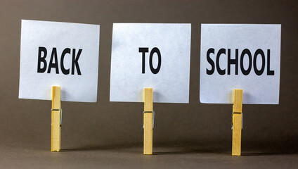 Back to school and support symbol. Concept words Back to school on white papers on wooden...