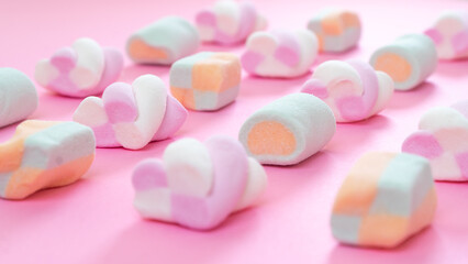 Obraz na płótnie Canvas Close-up of marshmallows on a pink background, delicate color of sweets