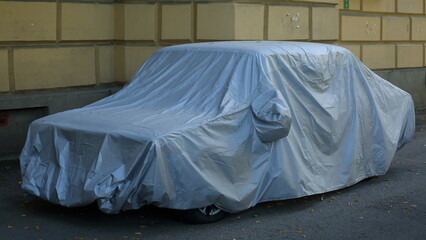 The car is covered with a cover for safety purposes