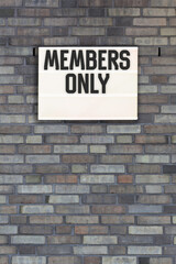 Fototapeta na wymiar members only message in light box on brick wall