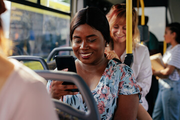 African american woman texting on bus