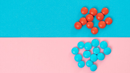 Blue and red candies on a two-tone background - bright collage