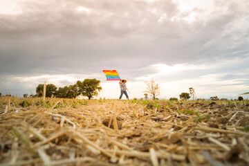 Fototapeta na wymiar senior woman walking with rainbow flag outdoors