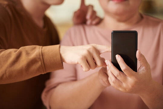 Boy Explaining Grandmother How to Use Social Media App