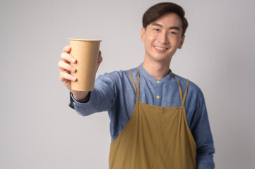 Portrait of young asian man wearing apron holding paper cup over white background studio, Save earth concept.