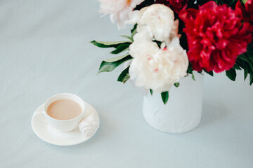 Modern home office concept. Computer, coffee and flowers.