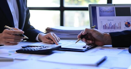 Successful teamwork Financial analysts analyze business financial reports on a digital tablet planning investment project during a discussion of corporate showing the results of their workspace 