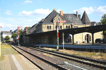 Historic train station in Goslar with railroad tracks, signals and the old station building made of...