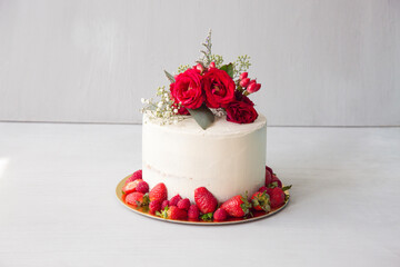 Naked white cake with red flowers topper