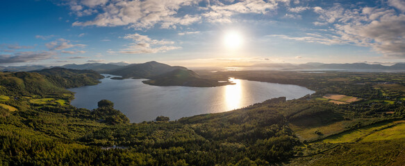 aerial panorama of Caragh Lake in County Kerry with the sun setting over the lake