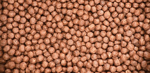 Whole grain cocoa cereal balls background.