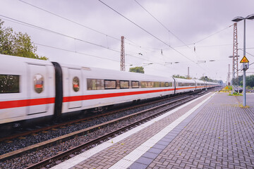 A modern high speed intercity train carries passengers. Public transport and technology. Blur in...