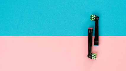 Electric toothbrush attachments on a two-tone background