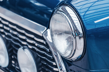 Headlamp on a retro car. Old-school style for motorists. Vintage automobile details and headlights illumination
