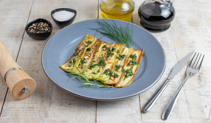 Fried Courgette on plate over wooden background with free text space. Top view