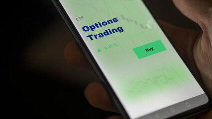 An investor's analyzing the option trading etf fund on screen. A phone shows the ETF's prices stocks to invest - obrazy, fototapety, plakaty