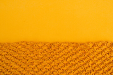 Yellow crochet net background with smooth empty space above.