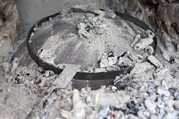 Cast iron Baking lid, Peka , covered with ashes.
Traditional Croatian cooking dish