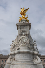Fototapeta na wymiar London, England, UK - July 6, 2022: Victoria Memorial. Enthroned queen with front view on golden Winged Victory. Buckingham Palace behind. Justice and Truth statues on sides