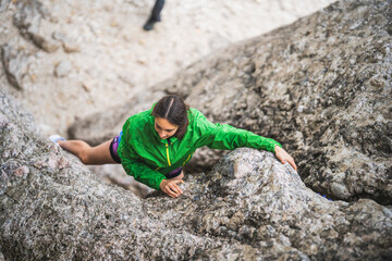 Pretty rock climber lady on a rock
