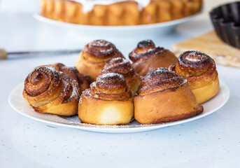 freshly baked buns on a white table.